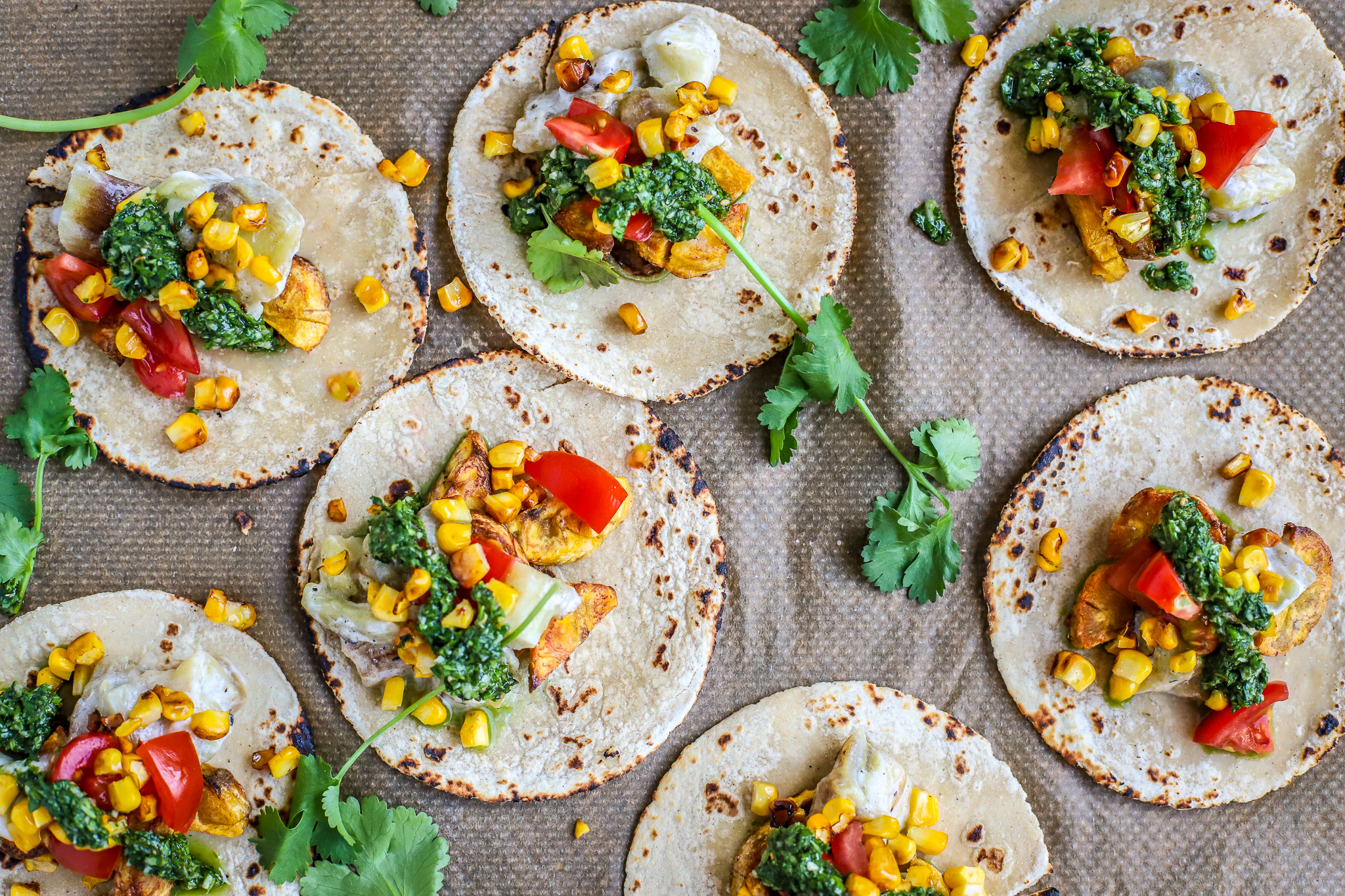flatlay of soft tacos with vegetables on baking paper